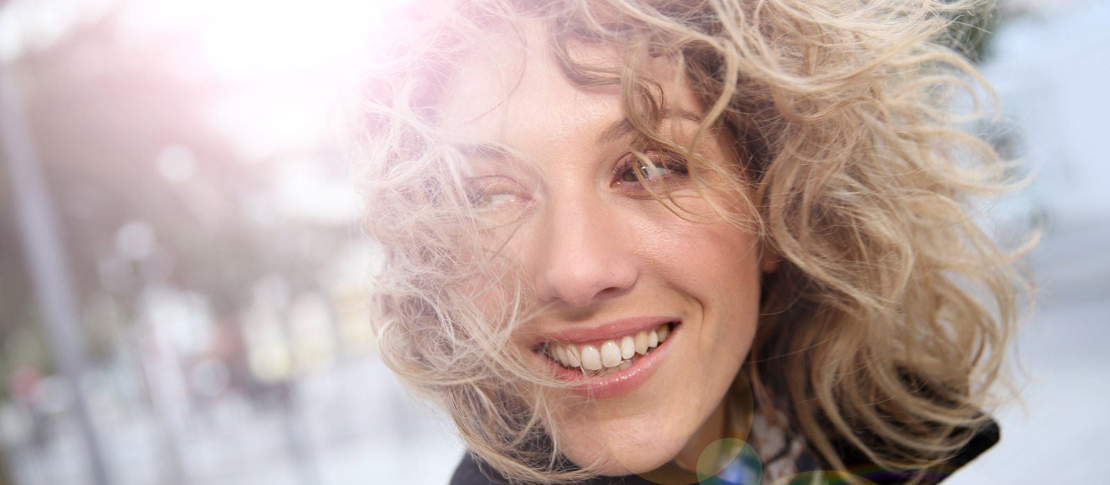 Smiling attractive woman in town in winter time
