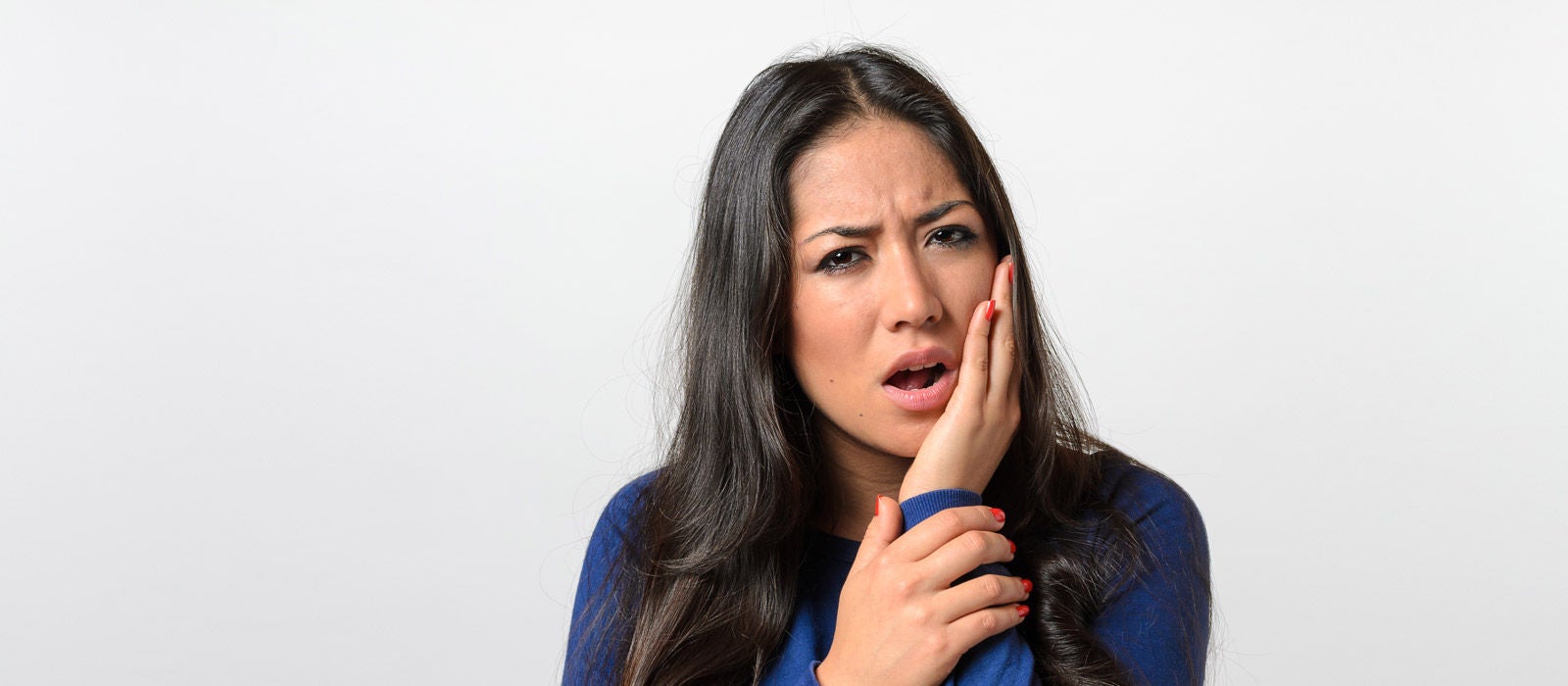 Portrait of Young Woman w/ toothache against white background