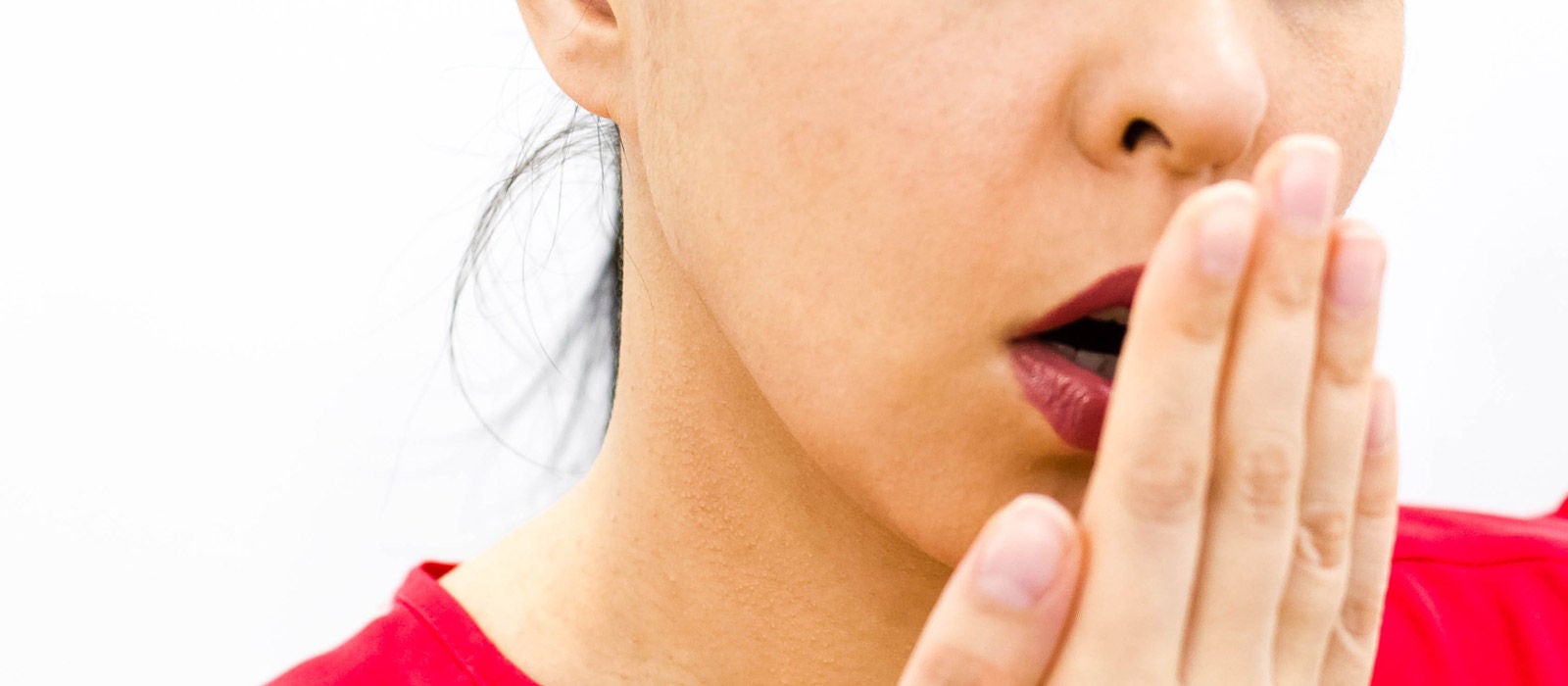 Health Care: Woman checking her breath with her hand. Closeup portrait headshot sleepy young woman with wide open mouth; 578517046